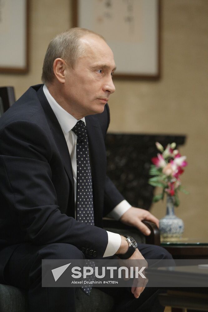 Russian Prime Minister Vladimir Putin talks to media