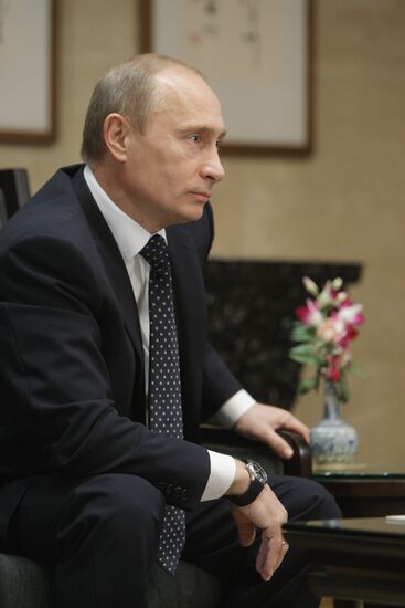 Russian Prime Minister Vladimir Putin talks to media