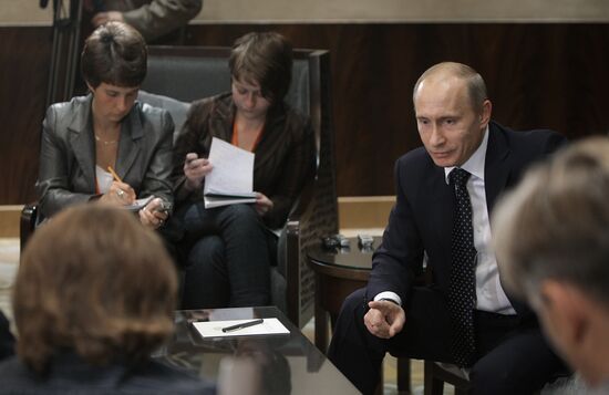 Russian Prime Minister Vladimir Putin talks to media