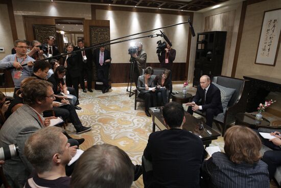 Russian Prime Minister Vladimir Putin talks to media