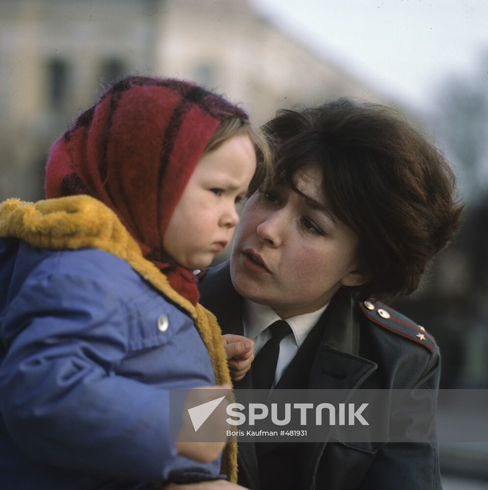 Juvenile delinquents' department inspector with a child