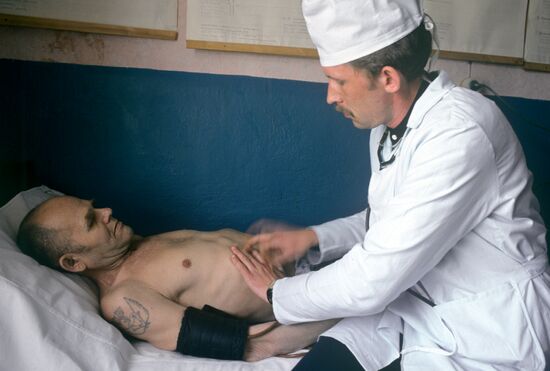 Doctor examining convict