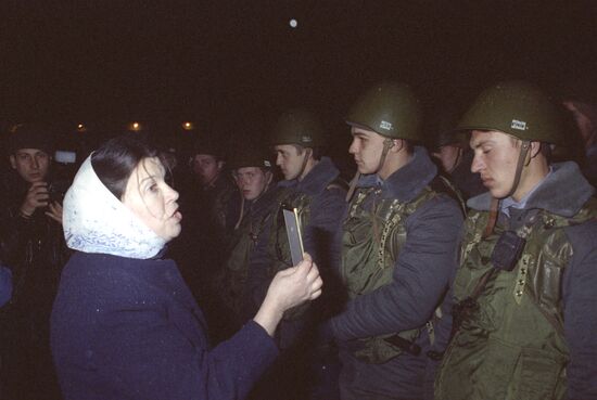 Woman talking with soldiers near Parliament House
