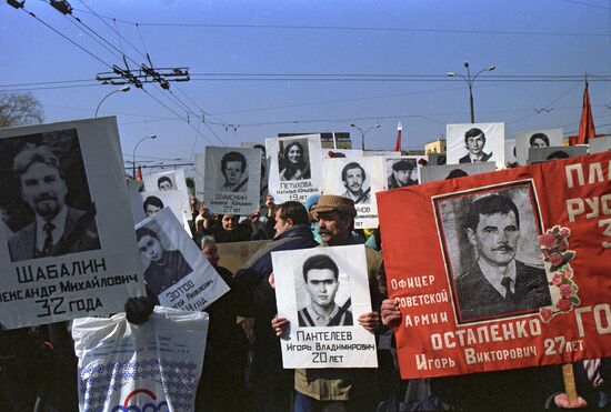 Rally activists carrying photos of died