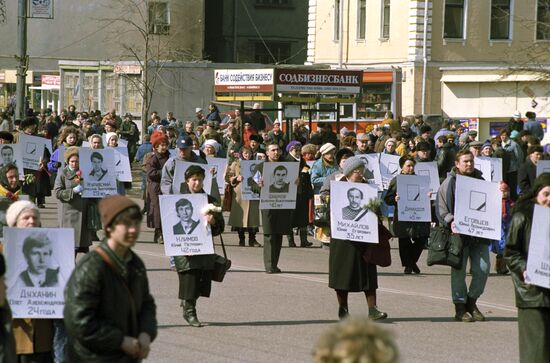 Rally activists carrying photos of died