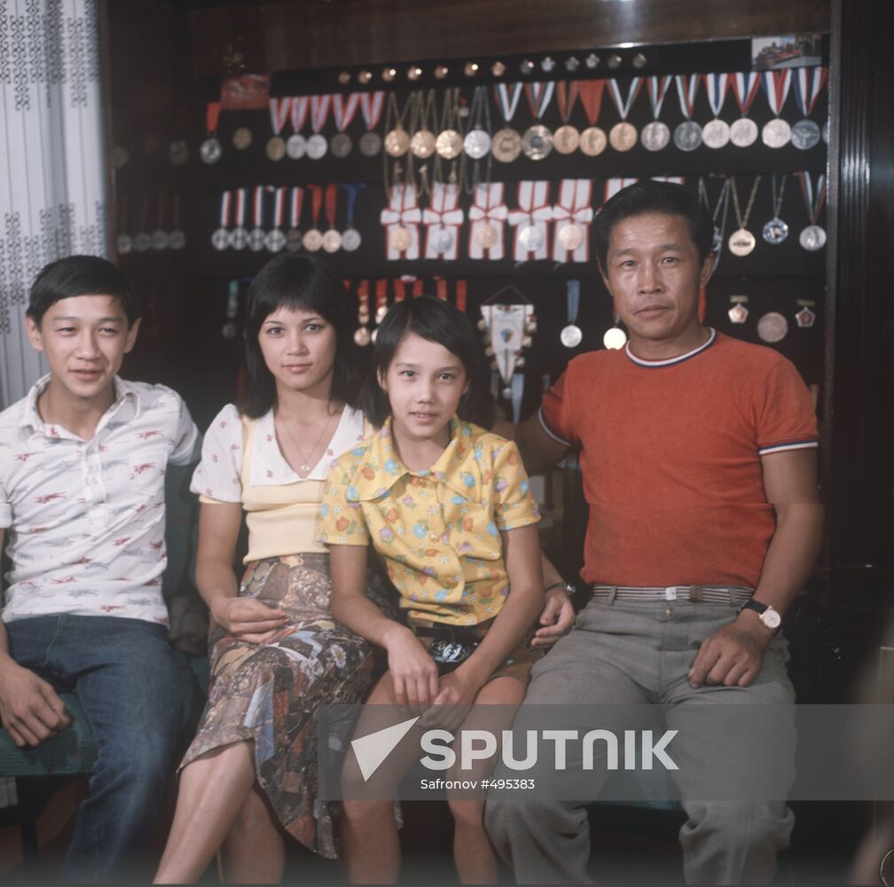 Nelli Kim with her family and her awards