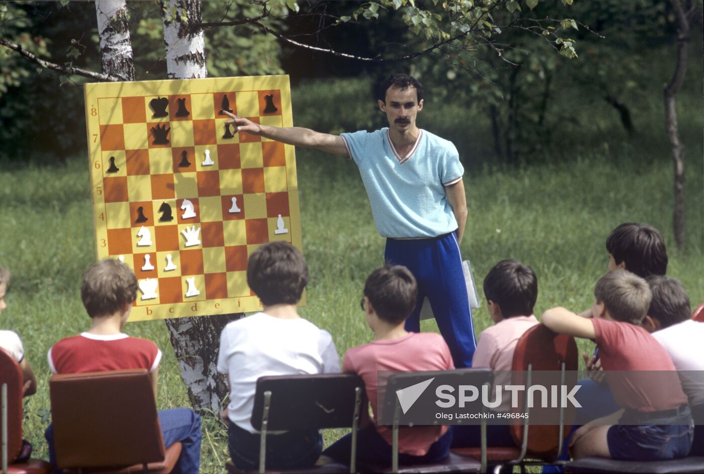 Coach with young chess players