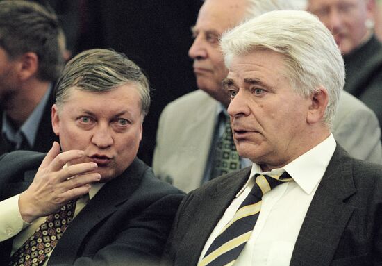 Russian chess grandmasters Boris Spassky, right, and Anatoly Karpov, left,  shake hands the news