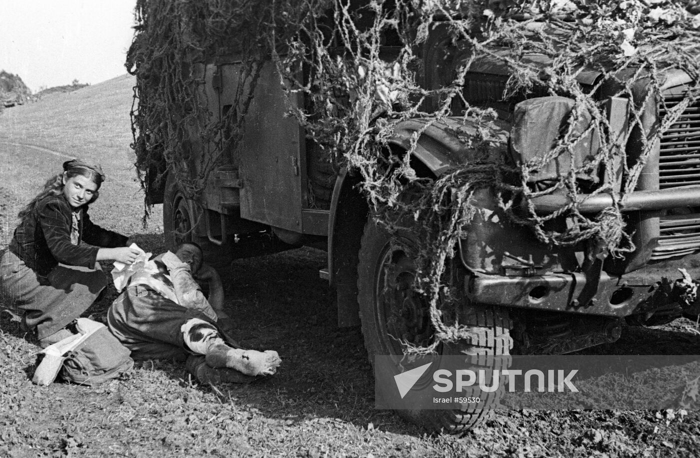 GIRL SOLDIER BANDAGING