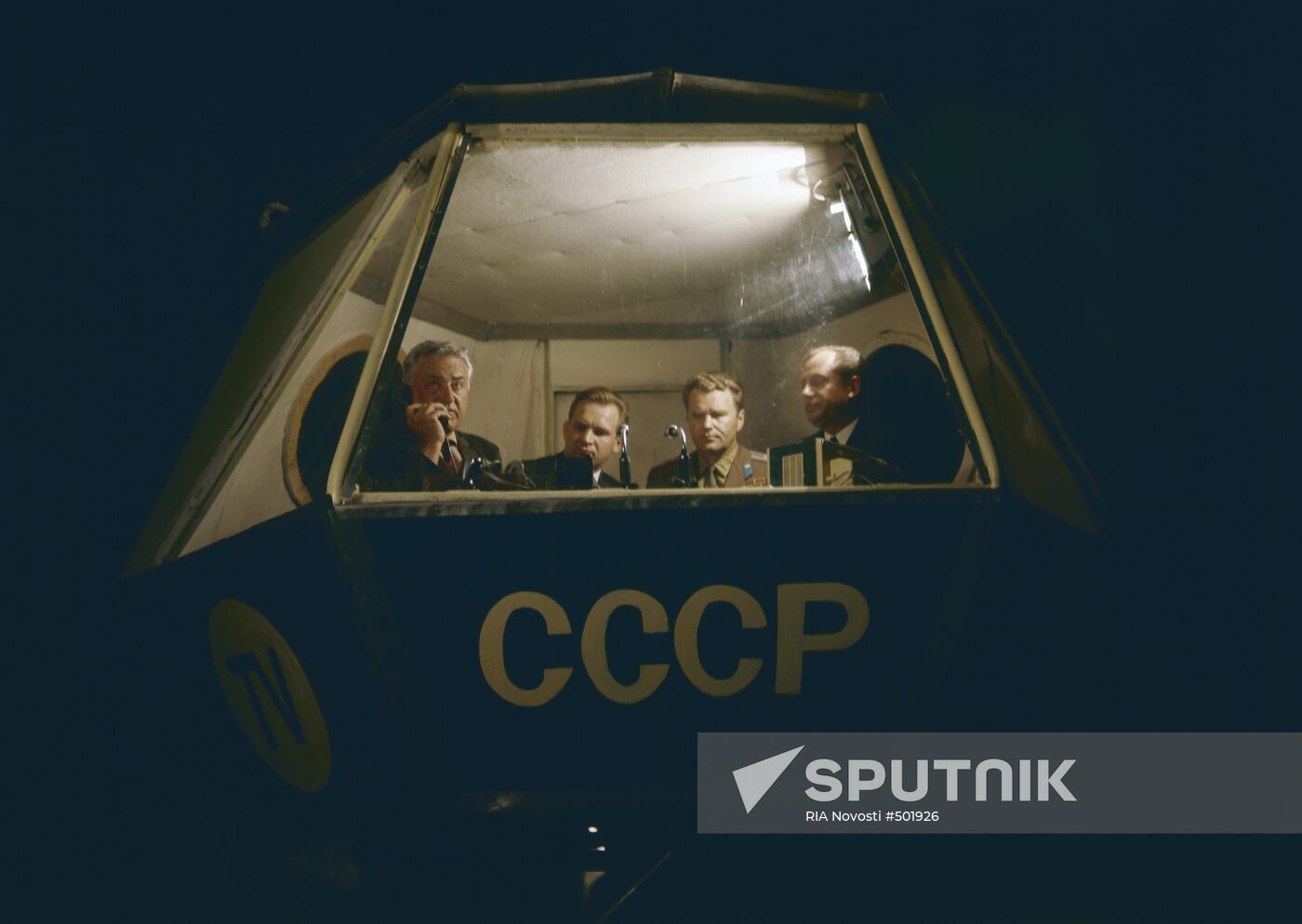 CT commentator Yury Fokin with cosmonauts Valery Kubasov and Vladimir Shatalov reports from space center