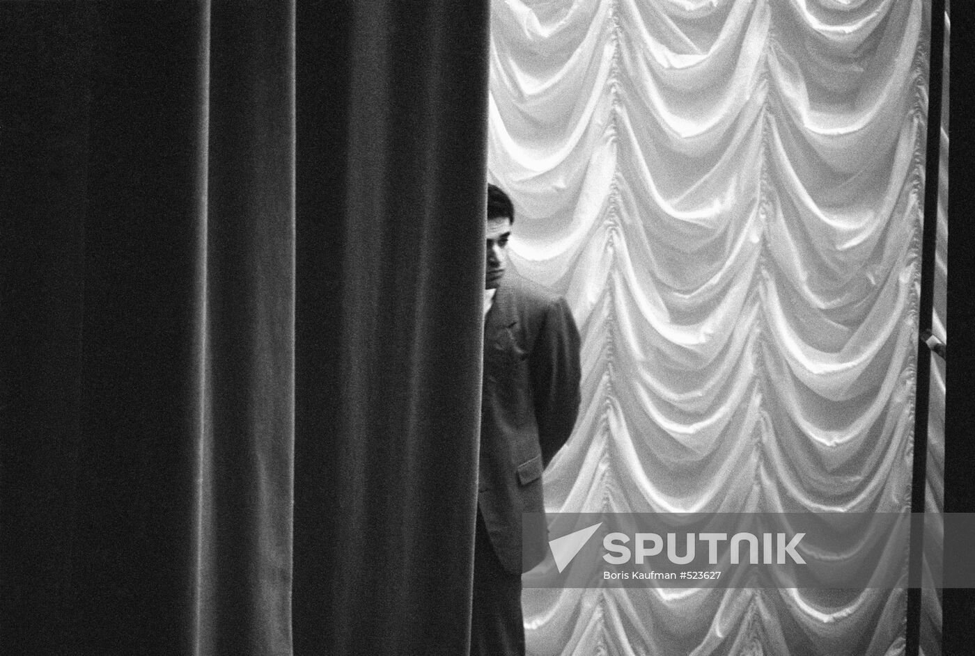 Garry Kasparov watching from behind curtains