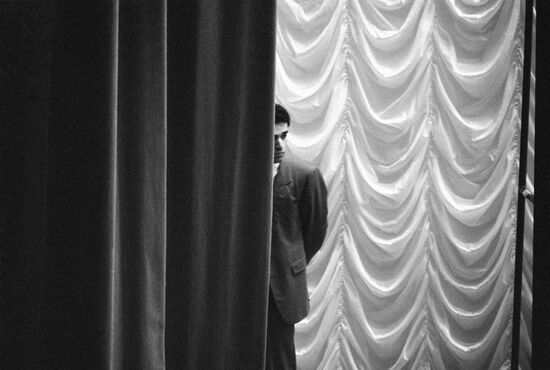 Garry Kasparov watching from behind curtains
