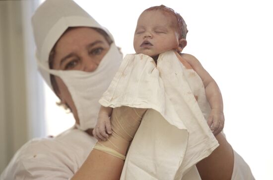 Midwife with a newborn baby