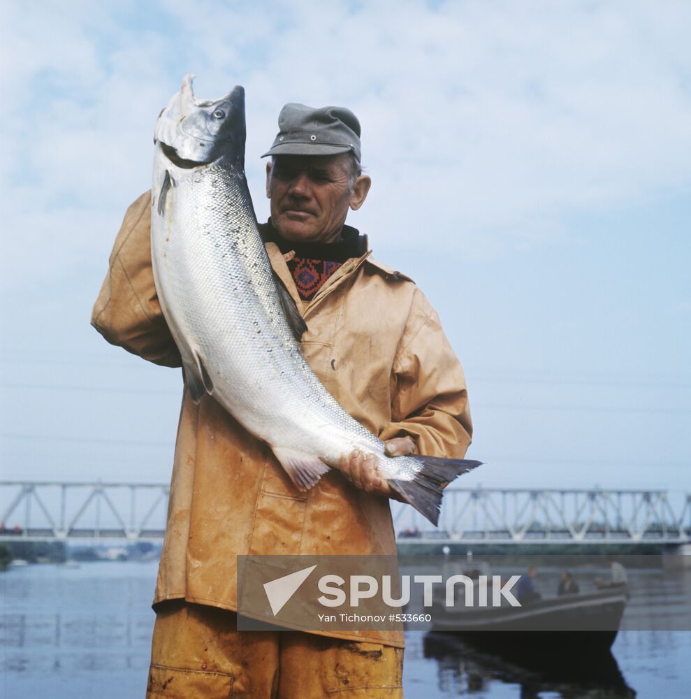 Fisherman Janis Bērziņš with salmon