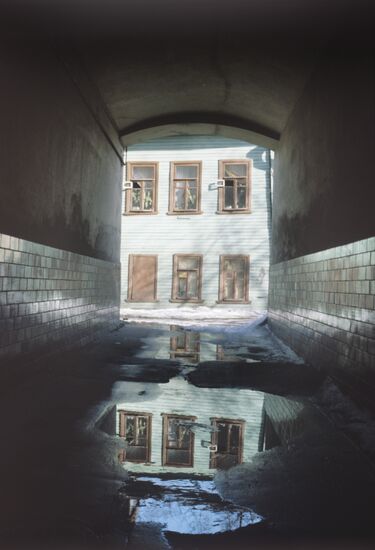 View through arch at wooden house