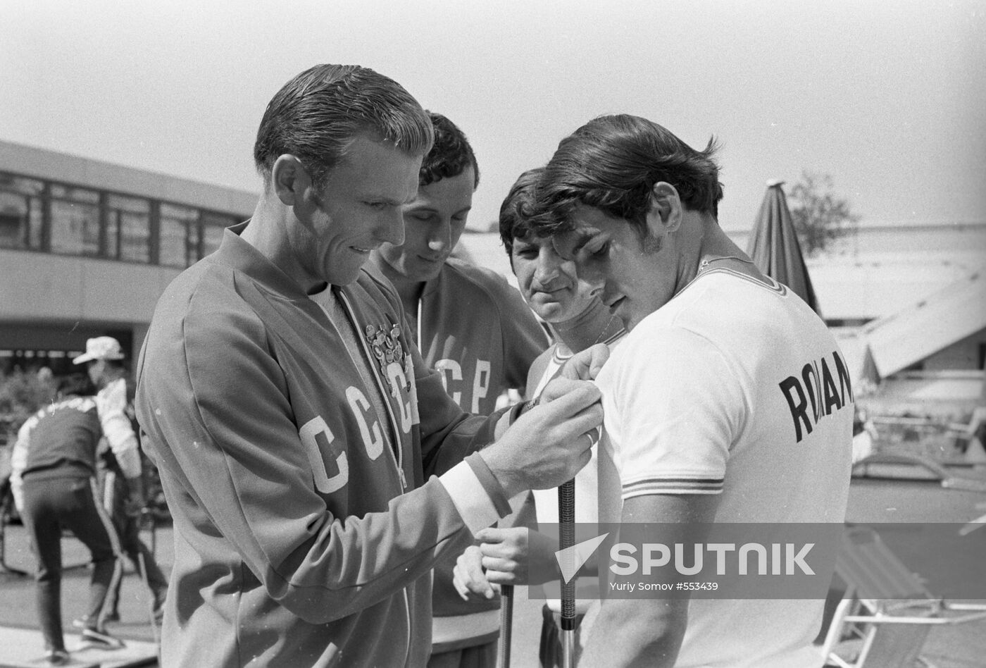 Athletes exchanging pins