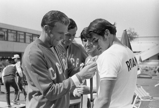 Athletes exchanging pins