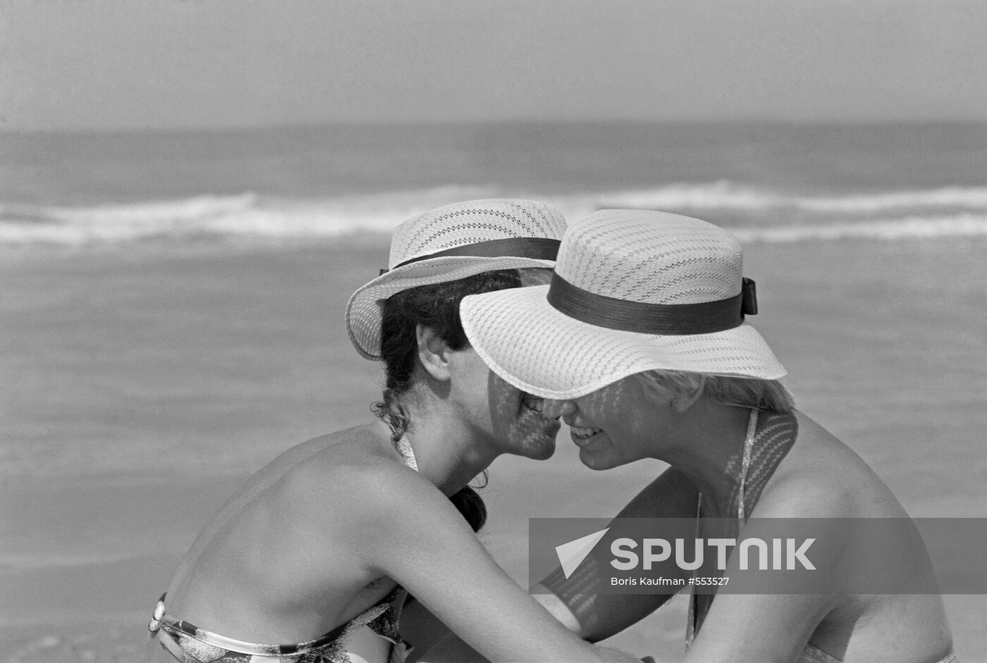Two girls gossip on Caspian beach near Gyandzhlik