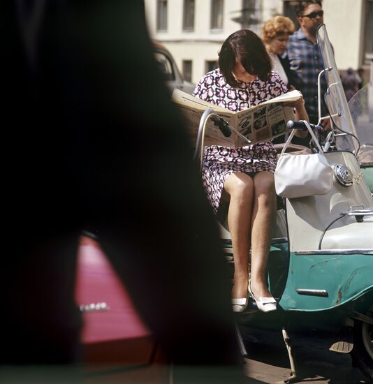 Girl reading newspaper