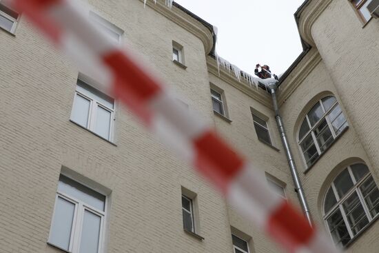 Removing snow and icicles from buildings in Smolensky Bulvar