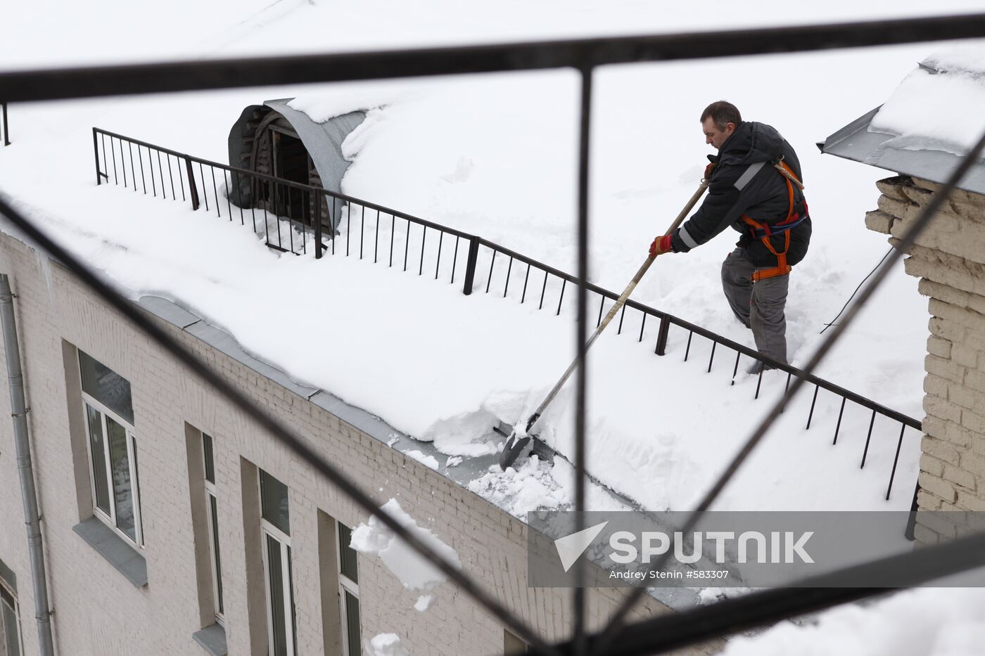 Removing snow and icicles from buildings in Smolensky Bulvar
