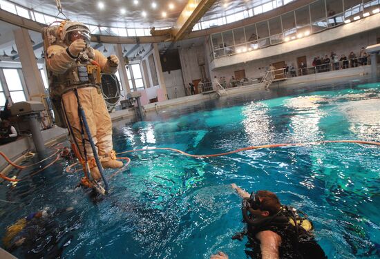 Cosmonaut diving into water at hydrolab training facility