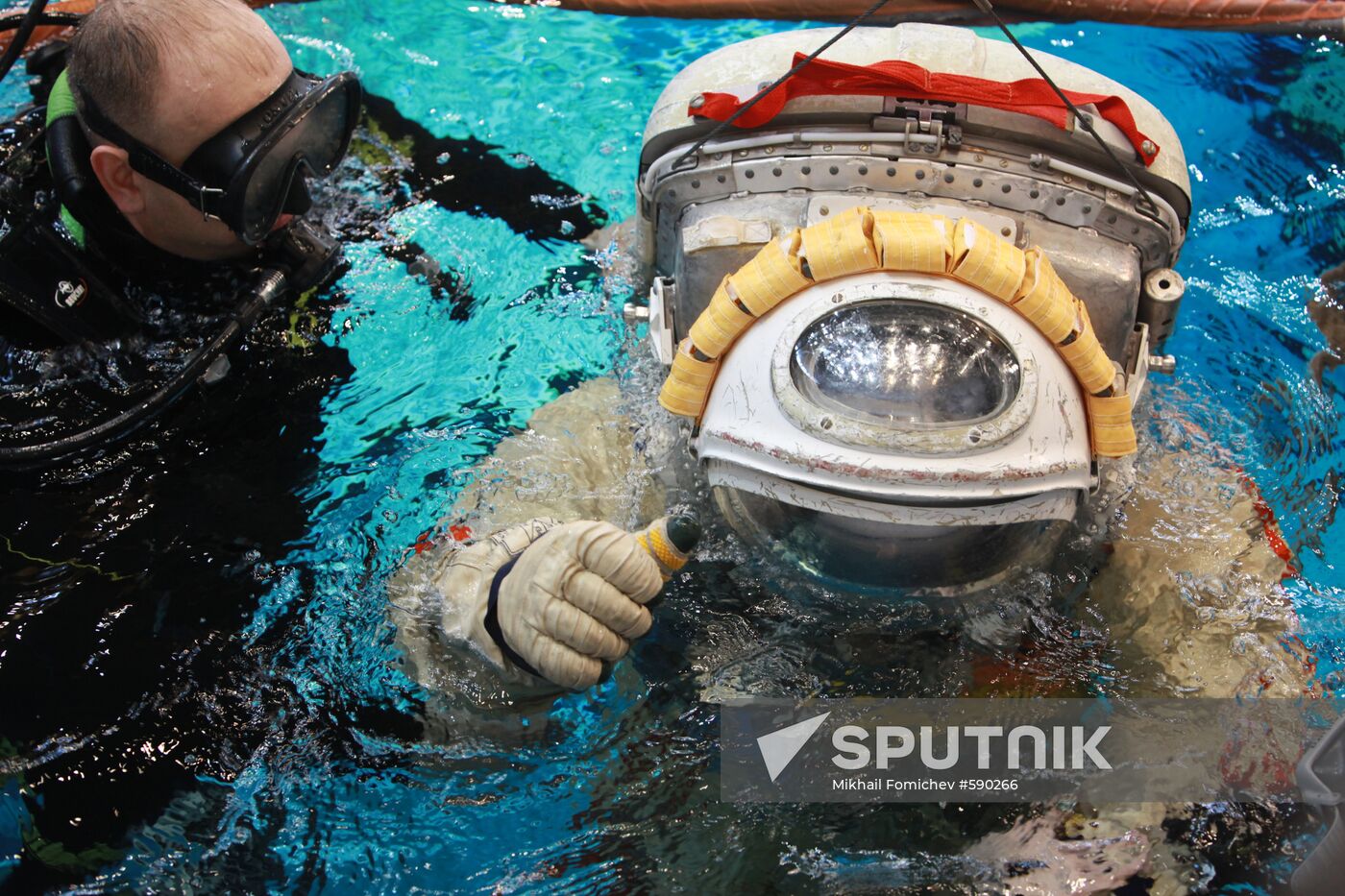 Cosmonaut diving into water at hydrolab training facility