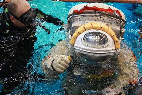 Cosmonaut diving into water at hydrolab training facility