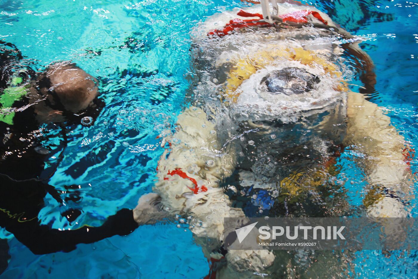 Cosmonaut diving into water at hydrolab training facility