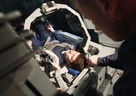 Preparing cosmonaut for tests at TsF-18 centrifuge