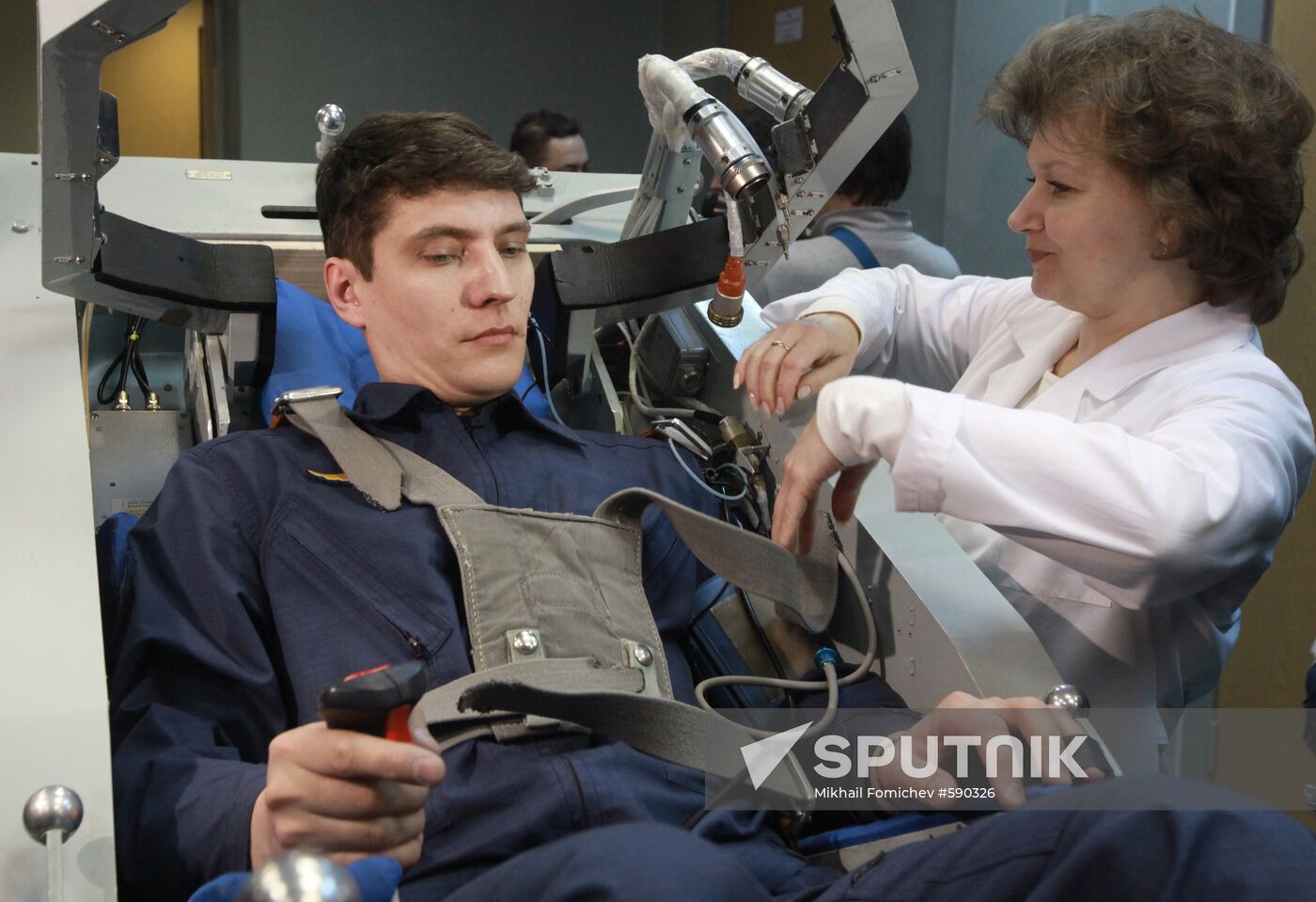 Preparing cosmonaut for tests at TsF-18 centrifuge