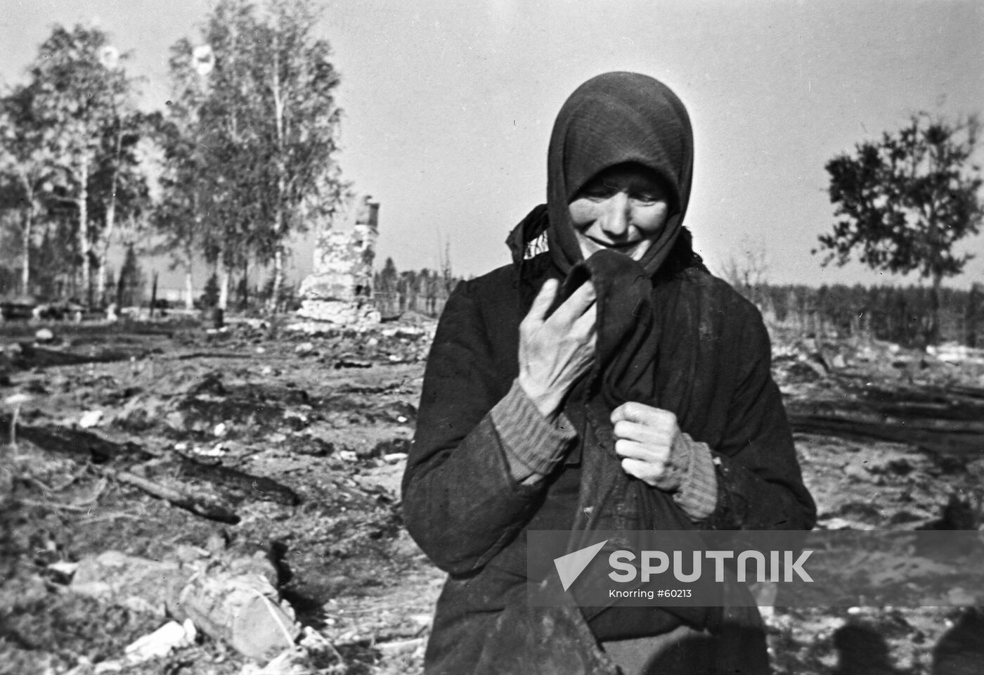 WOMAN GRIEF VILLAGE DEVASTATION WWII