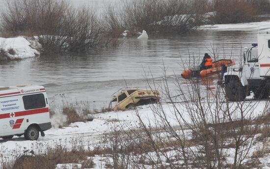 Car being lifted from river