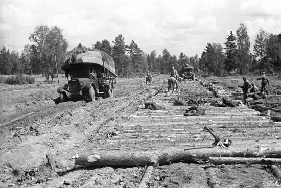 Soviet soldiers build the road on marshland