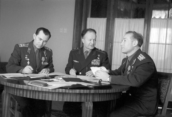 Cosmonauts Pavel Belyaev, Alexei Leonov and lieutenant general Nikolai Kamanin prepare for news conference