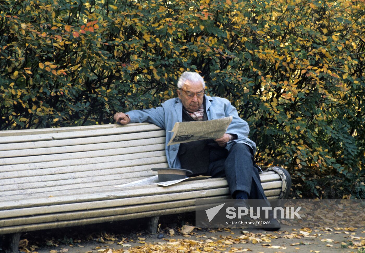 Man reading a newspaper in the park