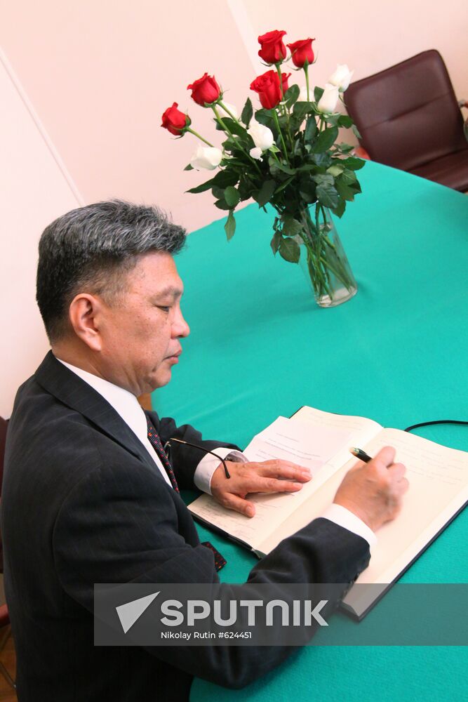 Visitor signing book of condolences