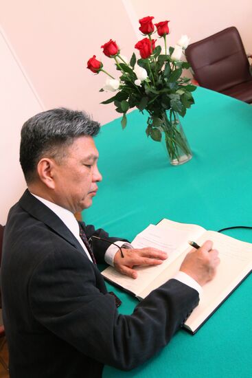 Visitor signing book of condolences