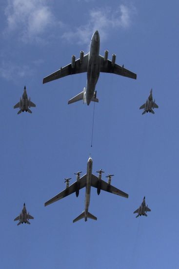 IL 78 refuels TU 95MS bomber accompanied by MiG 29 jets