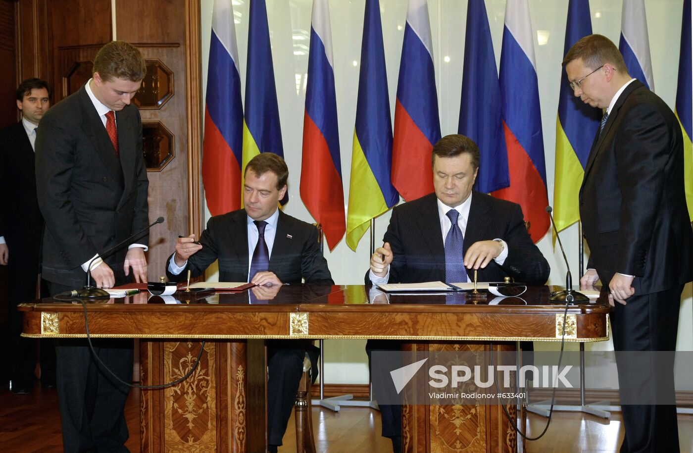 April 21, 2010. Russian President Dmitry Medvedev, left, and President of Ukraine Viktor Yanukovych, right, sign an extension agreement on Russian Black Sea Fleet presence in Crimea after 2017. Location: Ukraine, Kharkov. Author: Vladimir Rodionov/Sputnik. Dmitry Medvedev visits Ukraine