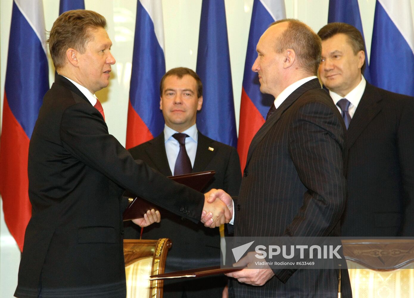 April 21, 2010. Russian President Dmitry Medvedev, background left, and President of Ukraine Viktor Yanukovych, background right, during the signing of the agreement between Gazprom chief Alexei Miller, front left, and Naftogaz of Ukraine chief Yevhen Bakulin, front right, on Russian gas supplies to Ukraine and gas transit to Europe in 2009-2019. Location: Ukraine, Kharkov. Author: Vladimir Rodionov/Sputnik. Dmitry Medvedev visits Ukraine