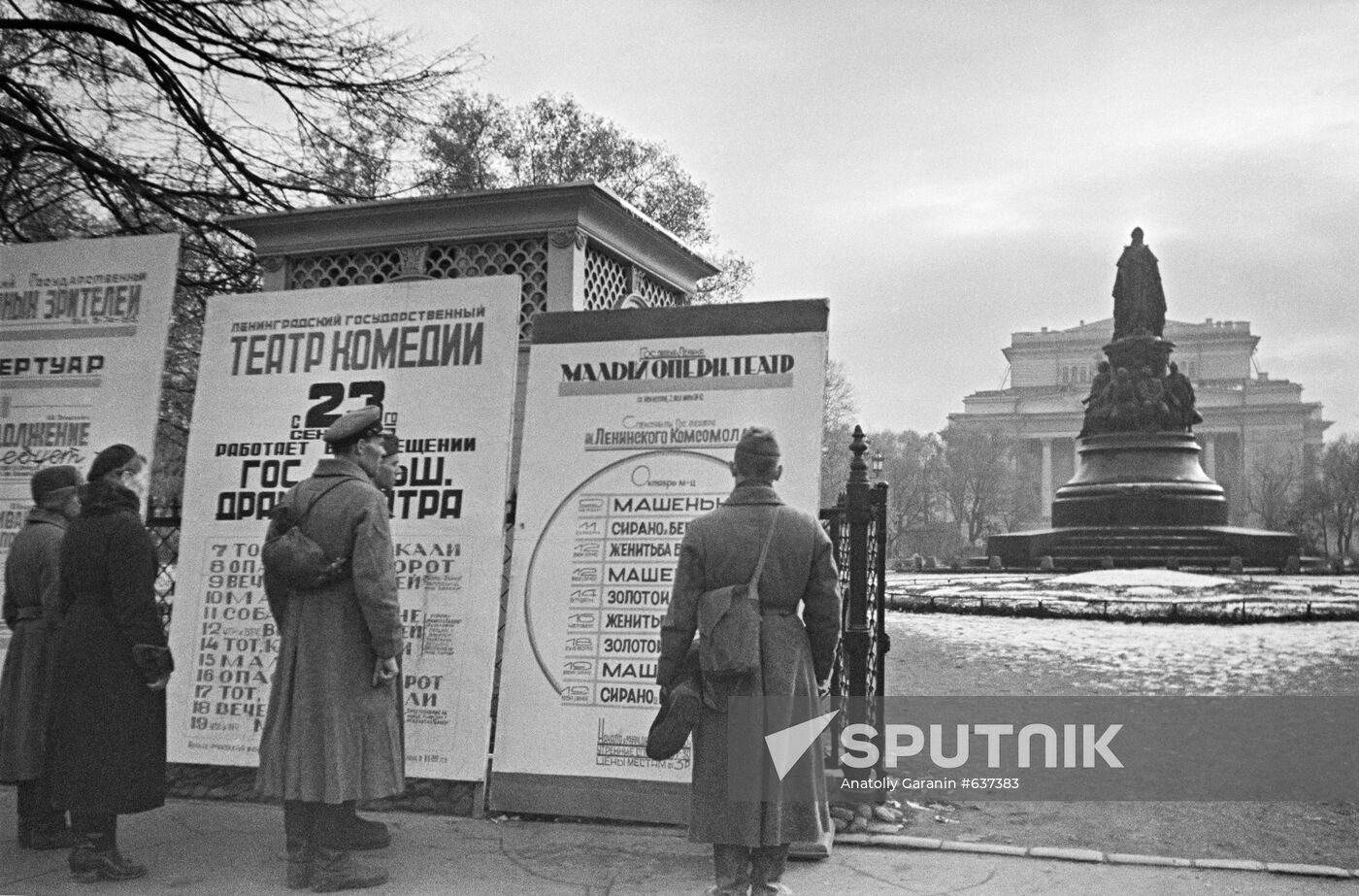 People in front of theater marquee