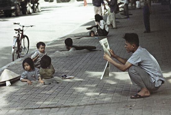 Residents of Hanoi after air-raid warning was sounded