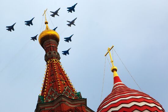 Military aircraft fly over Red Square