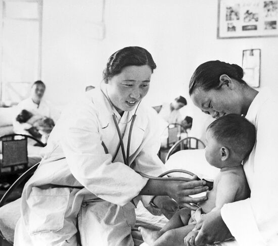 Children`s doctor examining a baby