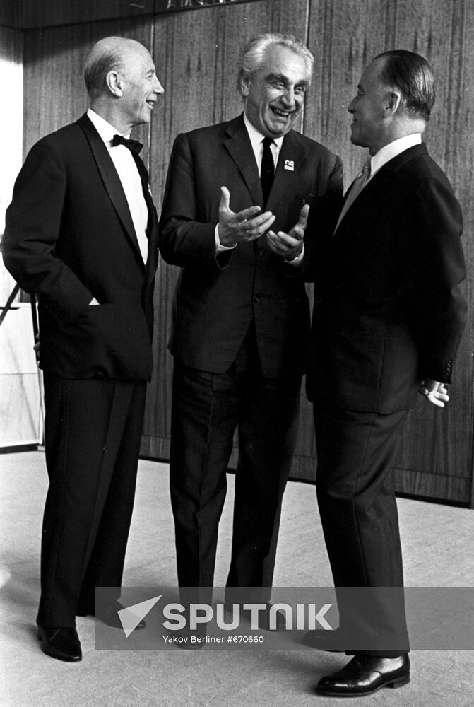 Soviet film director Grigory Alexandrov talks with Germany guests Guenter Schwarz and German Schwerin