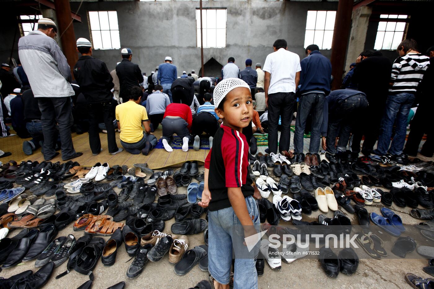 Believers attending Friday prayer at Uzbek community's mosque