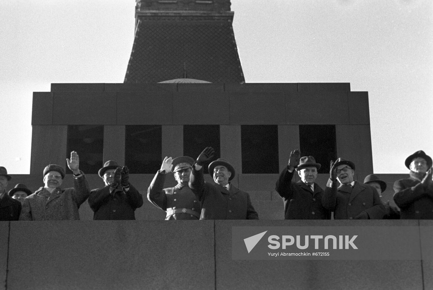 Communist statesmen stand atop Lenin Mausoleum