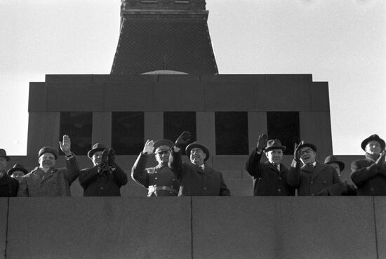 Communist statesmen stand atop Lenin Mausoleum