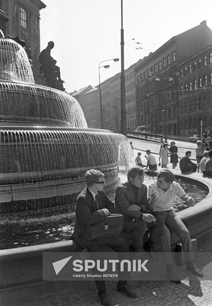 Young people resting near the fountain